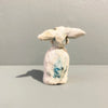 Rear View of Miniature figure with large 'listening ears' loosely inspired by creation stories, from folklore by contemporary ceramicist Sharon Griffin showing makers mark