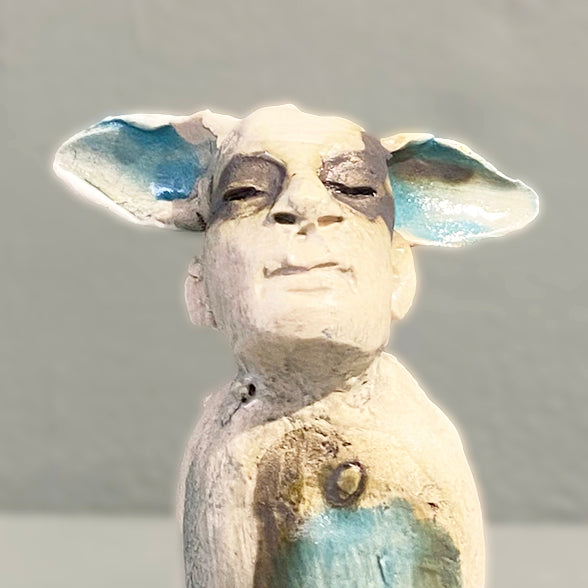 Close Up of Miniature figure with large 'listening ears' loosely inspired by creation stories, from folklore by contemporary ceramicist Sharon Griffin