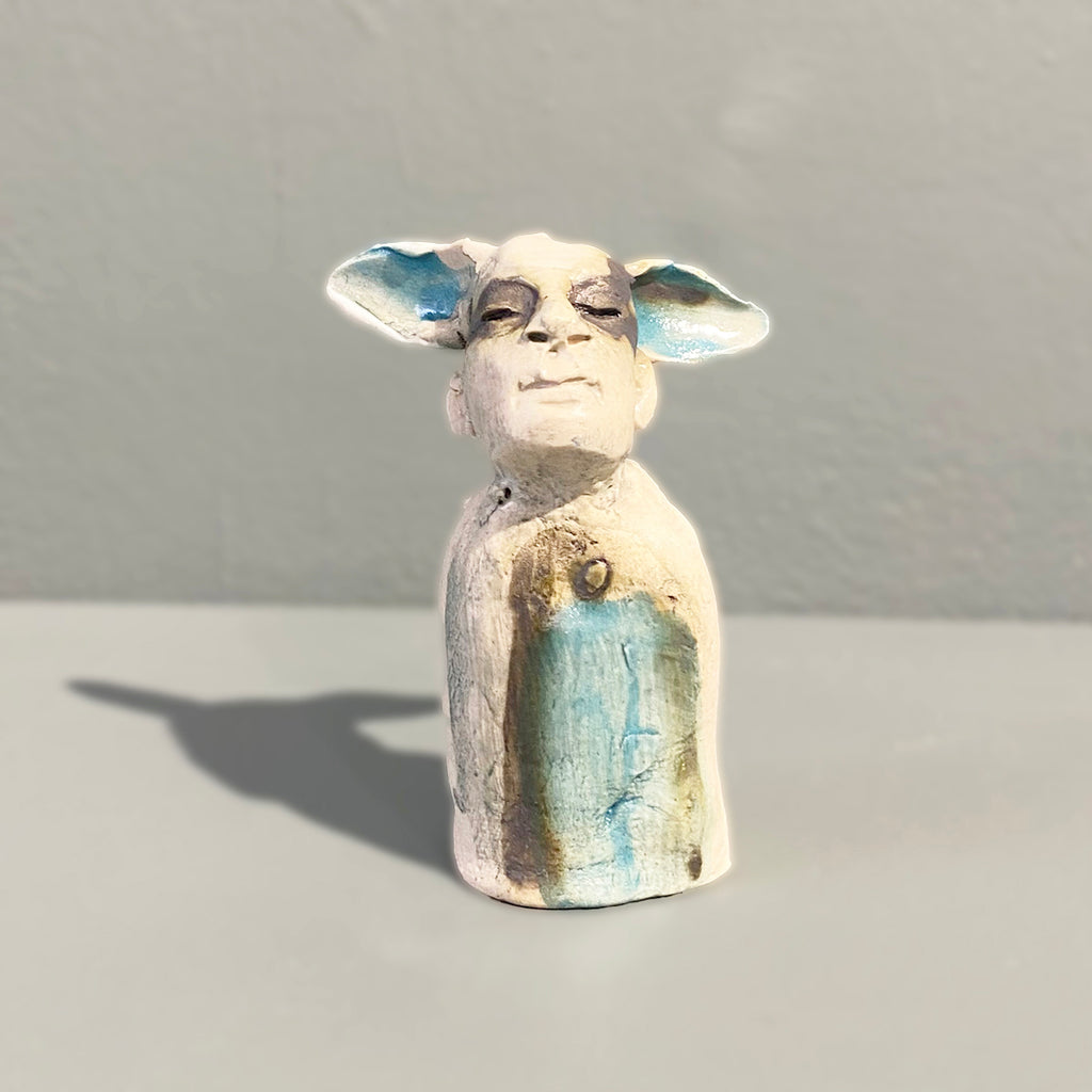 Miniature figure with large 'listening ears' loosely inspired by creation stories, from folklore by contemporary ceramicist Sharon Griffin