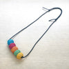 A multicolored paper beaded necklace with an adjustable leather strap by Irish maker Rike Lenzing shown at the bluecoat display centre