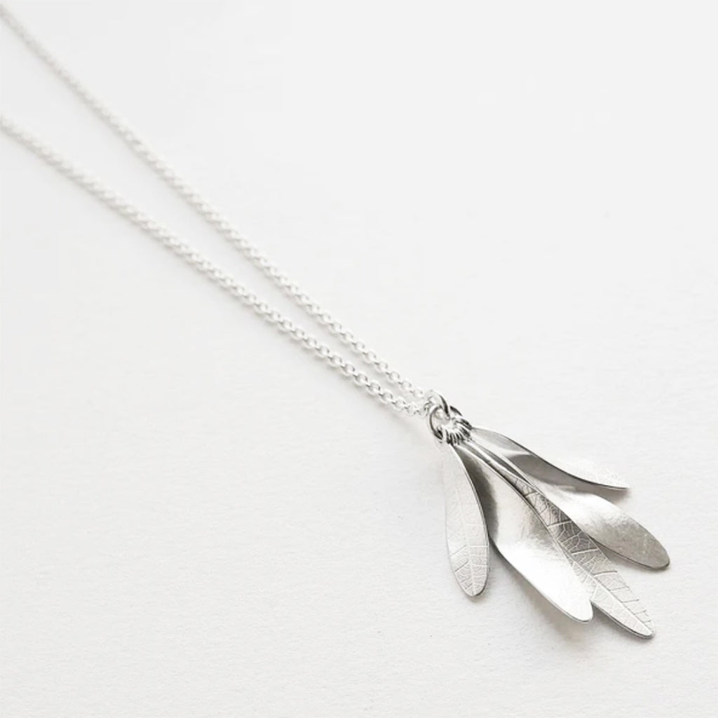 sterling silver pendant inspired by clusters of ash seeds, with leaf skeleton imprints on one side. Each key hangs separately so it has lovely movement.  photographed on an angle on white background