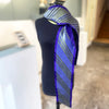 Mannequin wearing loosely thrown statement noon  scarf in Purple/Indigo by Nawal Gebreel at the Bluecoat Display Centre