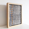 side view of Framed textile art featuring a bold design comprised of orange dots in a stitched grid by Irish textile artist Patricia Kelly