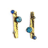 Close up of Rapids 4 Earrings - crafted from gold plated sterling silver, these studs feature London blue topaz, sapphire and lab diamonds. By contemporary jeweller Sam Holmes