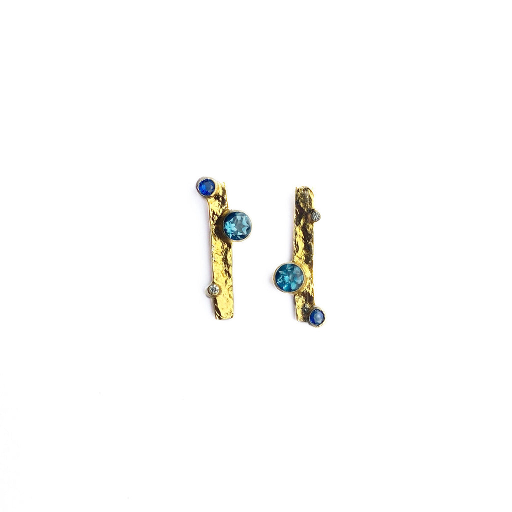 Crafted from gold plated sterling silver, these studs feature London blue topaz, sapphire and lab diamonds. By contemporary jeweller Sam Holmes
