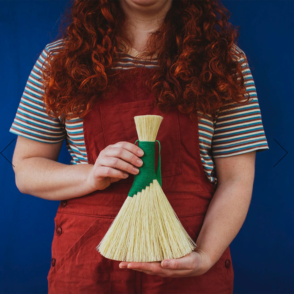Person holding a Tampico brush in a striking green - perfect for work surfaces in the home, workshop or garden. 