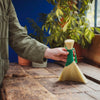 Person using a Tampico brush in a striking green - perfect for work surfaces in the home, workshop or garden. 