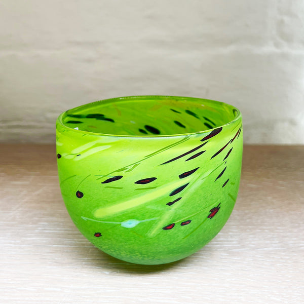 A small bowl by contemporary glass artist Will Shakspeare. The piece is inspired by the landscape of the Somerset Levels and is predominently green in colour.