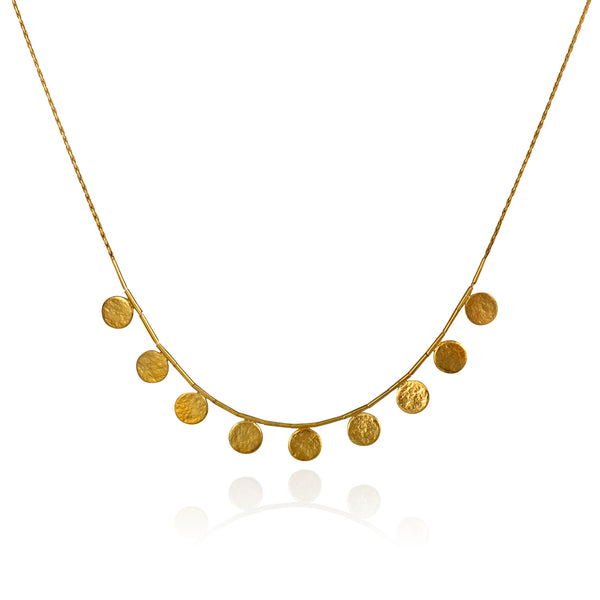 stunning short delicate necklace  with golden discs made of sterling silver with a gold vermeil finish by contemporary jeweller Cara Tonkin. Image show shaddows

