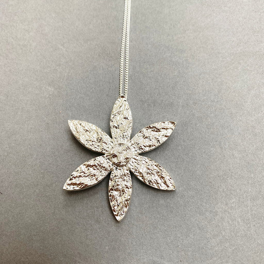 Close up of flower pendant by Irish Silversmith Kevin O’Dwyer in sterling silver