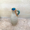 top view of slim stoneware bottle vase with a blue twisted handle. The base of the twisted handle is adorned with John Kershaw’s signature stamp