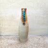 side view of slim stoneware bottle vase with a blue twisted handle. The base of the twisted handle is adorned with John Kershaw’s signature stamp