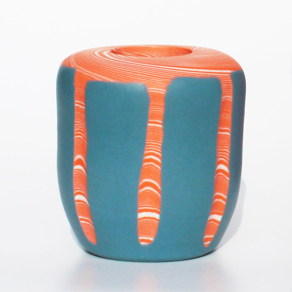 by Contemporary Irish Ceramicist Corinne Price a tangerine and blue nerikomi vase features a bright hand formed design; the coloured clay pattern acting as the main design feature of the vase. 