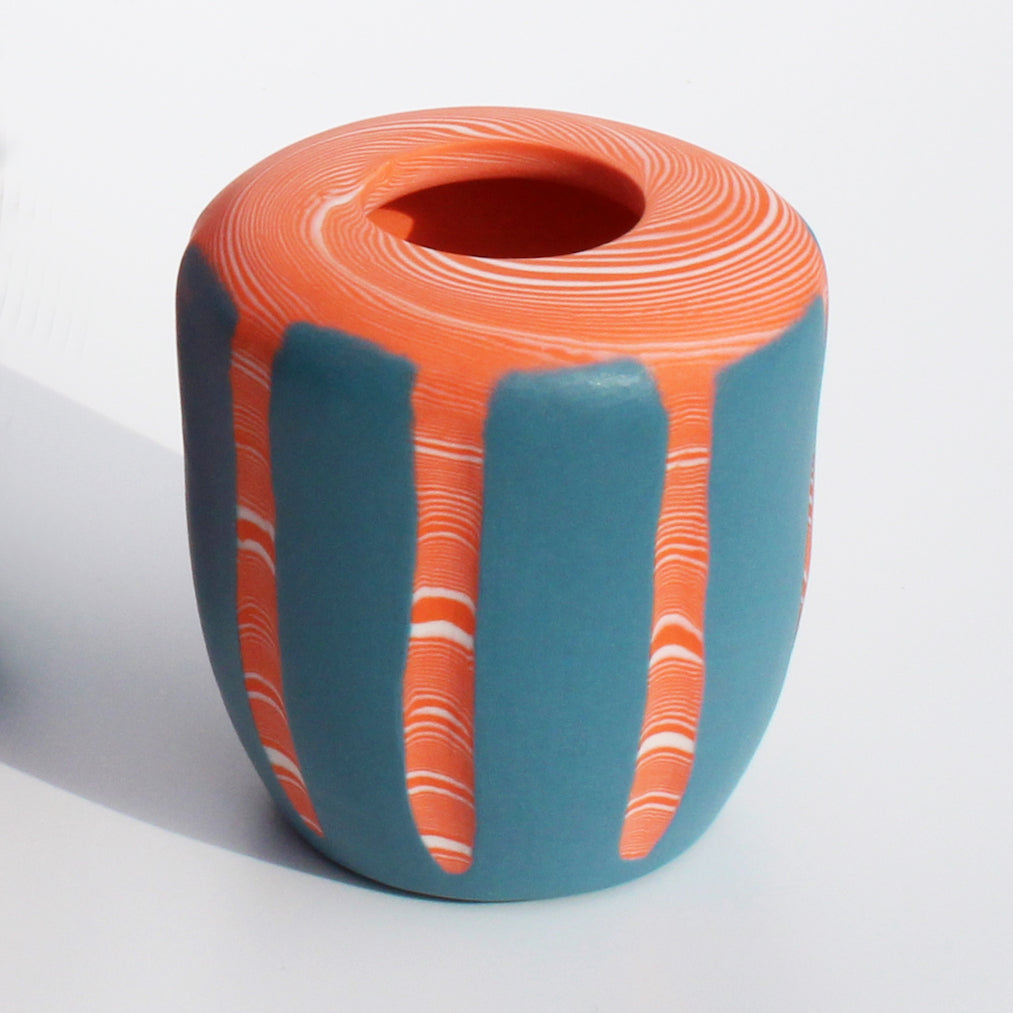 tangerine and blue nerikomi vase features a bright hand formed design; the coloured clay pattern acting as the main design feature of the vase by contemporary ceramicist Corinne Price