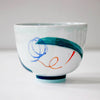 White bowl with colorful abstract designs on a white background by Irish Contemporary Ceramicist Anam Frew