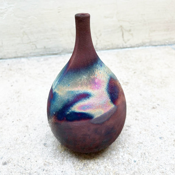 small raku vessel fired using Raku by 
Bryony Rich, with fumed copper oxide on her raku vessels, which gives an infinite spectrum of exciting colours and surface qualities