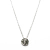 round etched silver pendant with a diamond in the centre on a fine trace chain by contemporary jeweller diana porter
