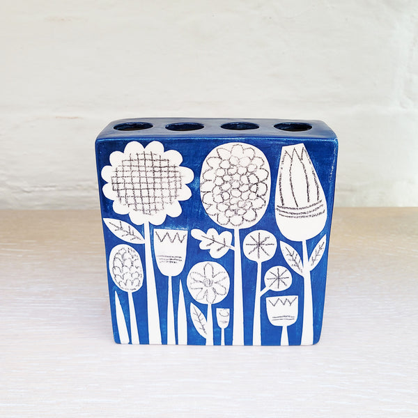 small rectangular flower brick is both functional and decorative on it's ow.  It is a striking teal colour and features Ken Eardley's distinctively retro patterns which are reminiscent of Scandinavian folk art. 