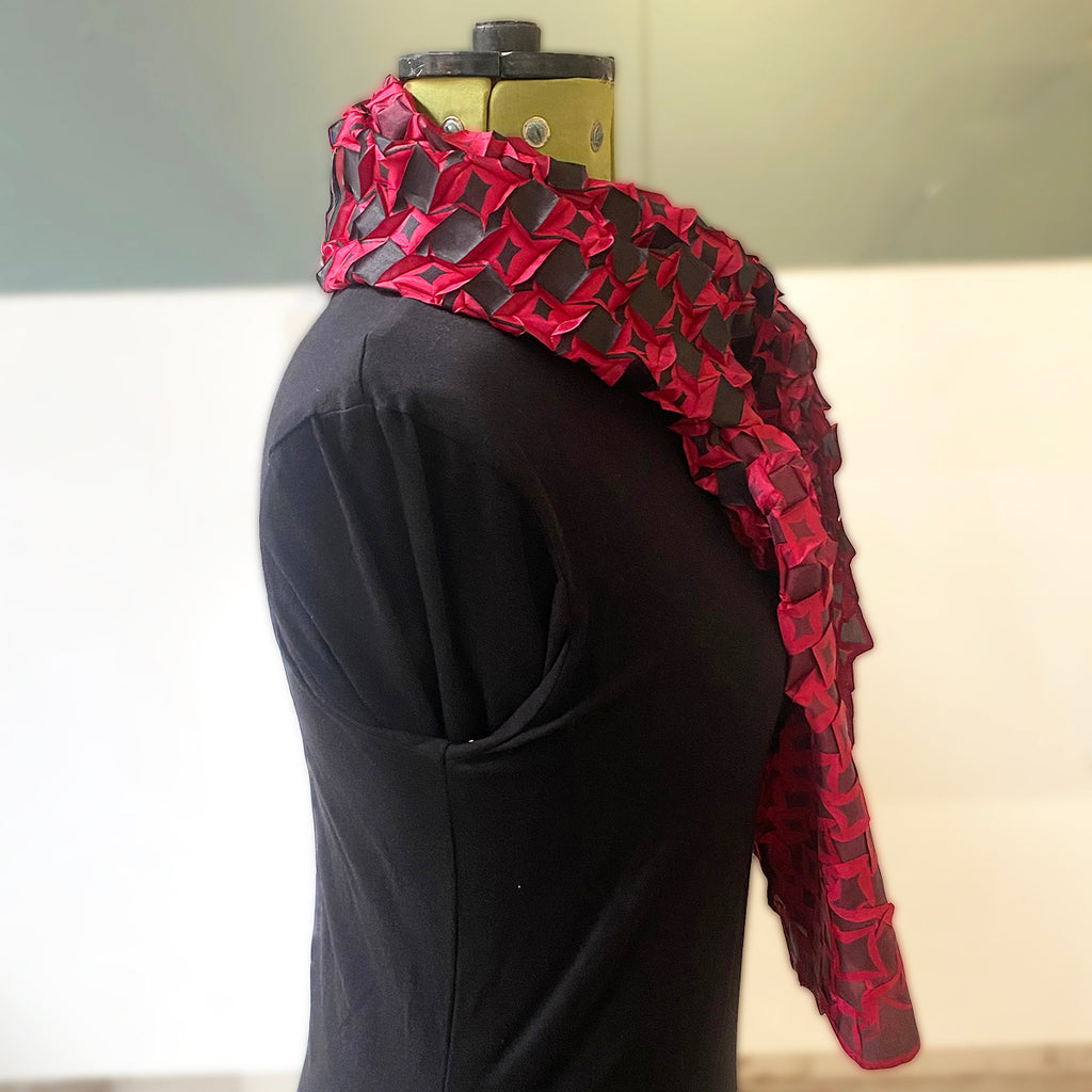 star pleat printed scarf by Nawal Gebreel shown from the side when tied around a manequin
