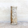 A rough textured flat vase in neutral colours, and a blue glazed interior