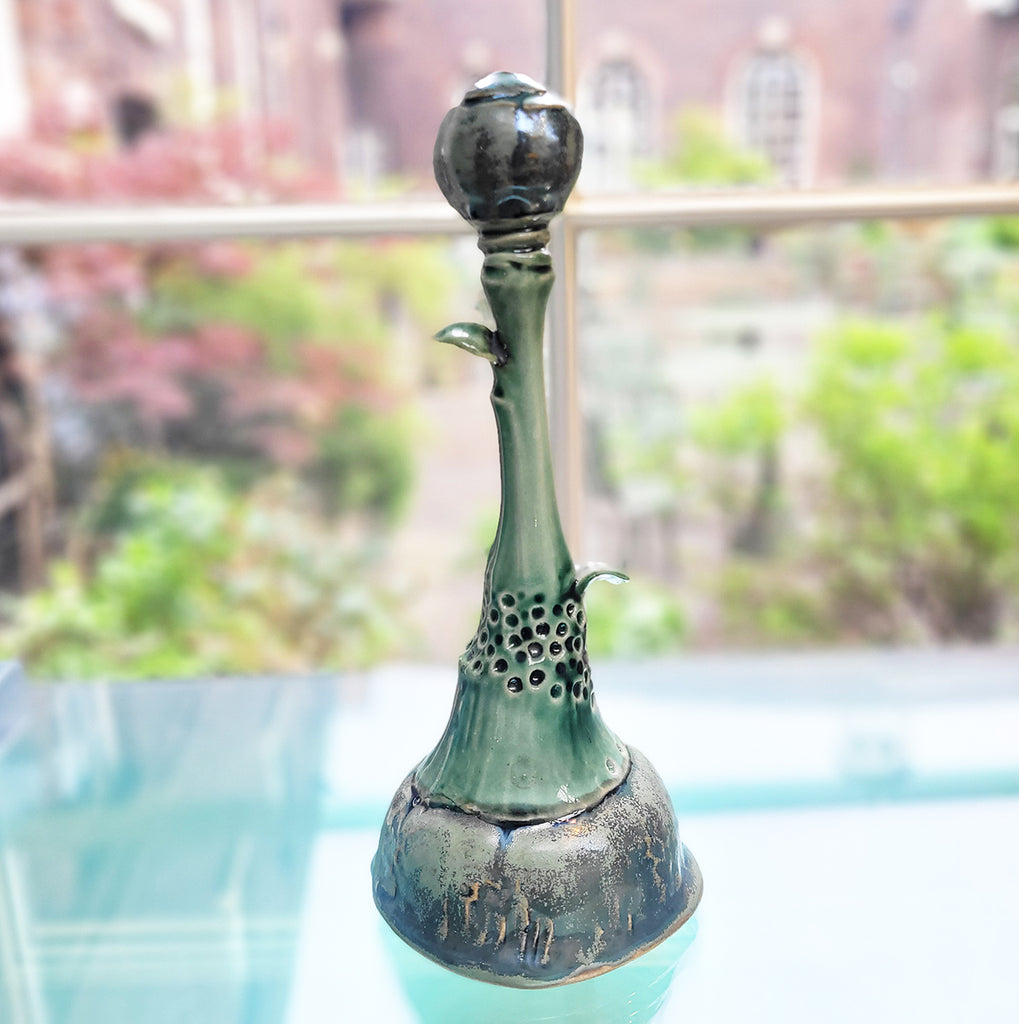 side view of A tall botanical sculpture by Michelle Young Hares - a fantastic piece of contemporary ceramic art