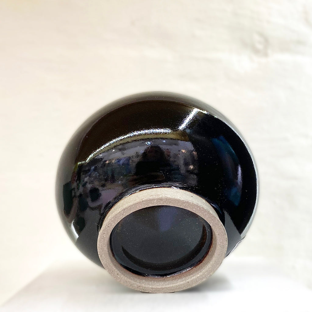 base of stunning stoneware bottleneck budvase by contemporary ceramicist Daniel Smyth glazed in a traditional Japanese glaze called tenmoku