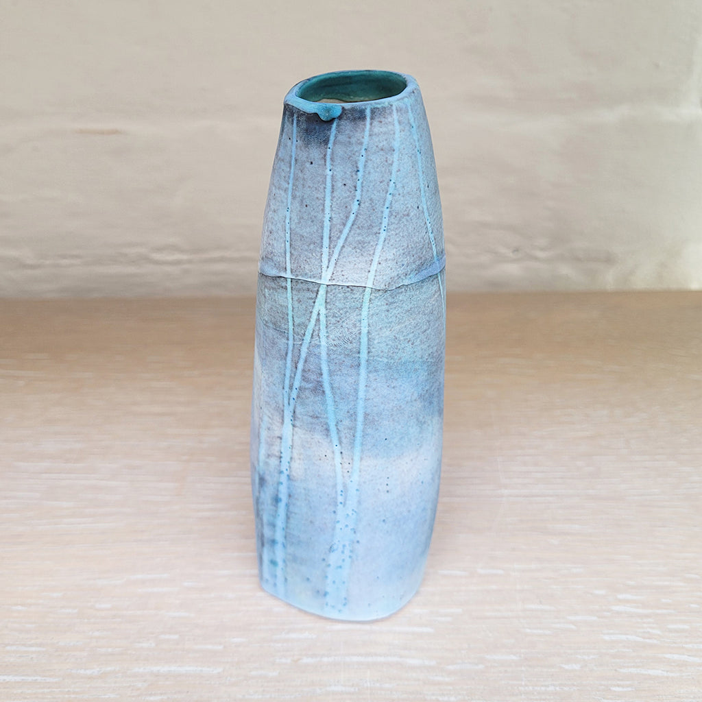 Hand built stoneware vase, great for a small posy of flowers. The woodland design is based on winter trees and features blues
