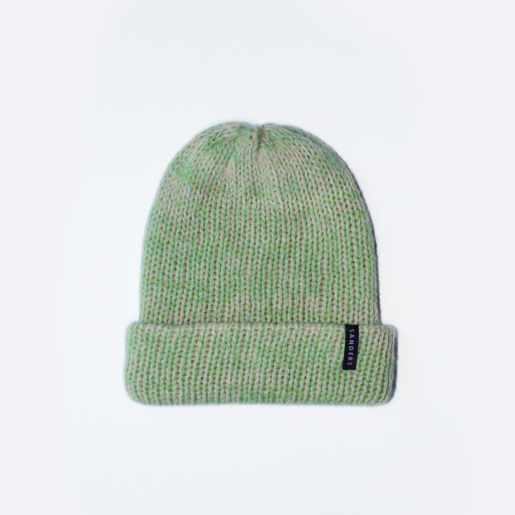 Green and pink knit beanie by Millicent Sanders on a white background