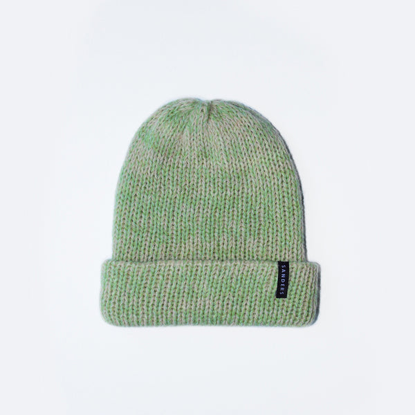 Green and pink knit beanie by Millicent Sanders on a white background