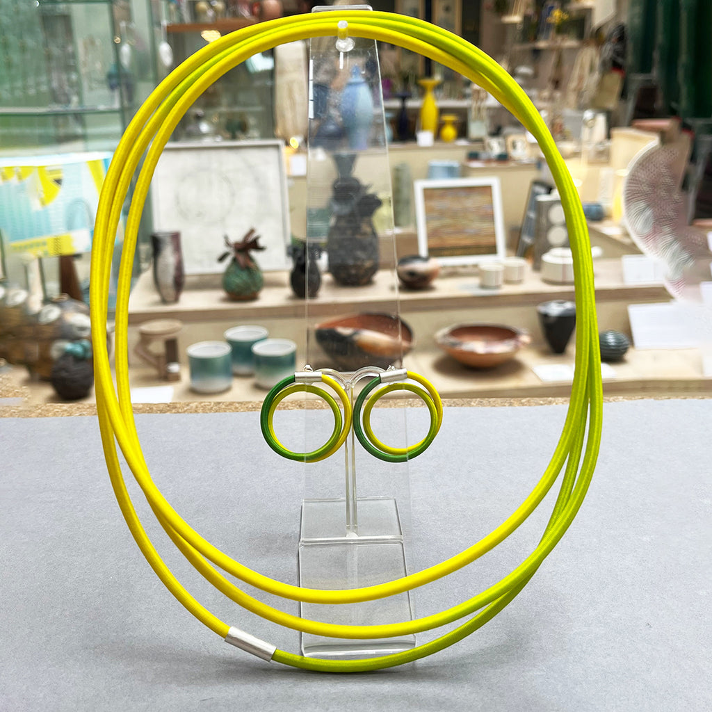 Double Loop Lemon & Lime earstuds by Gilly Langton in silver and hand dyed elastic shown with co-ordinating String necklace by the same artist photographed at the Bluecoat Dispay Centre