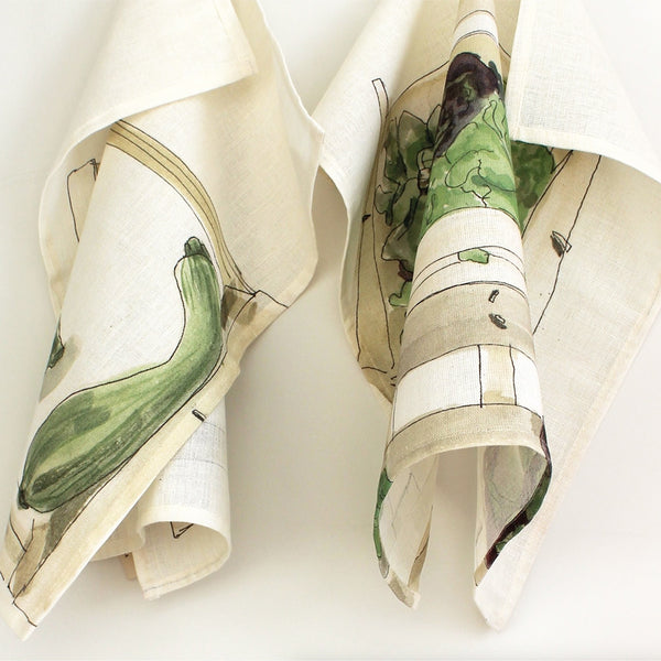 pair of Striped Courgette and Curly Lettuces napkins which originate from Helen Beard's sketches made in the South of France, the markets being one of her favourite subjects to draw. 