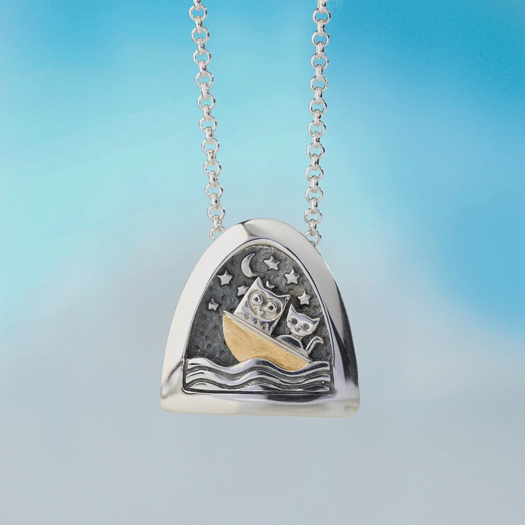 movie of silver kinetic pendant by Alan Ardiff Contemporary Irish Jeweller.  based on the famous poem the owl and the pussycat. The pendant features a silver owl and pussycat going to sea in a gold boat amongst the rocking waves.