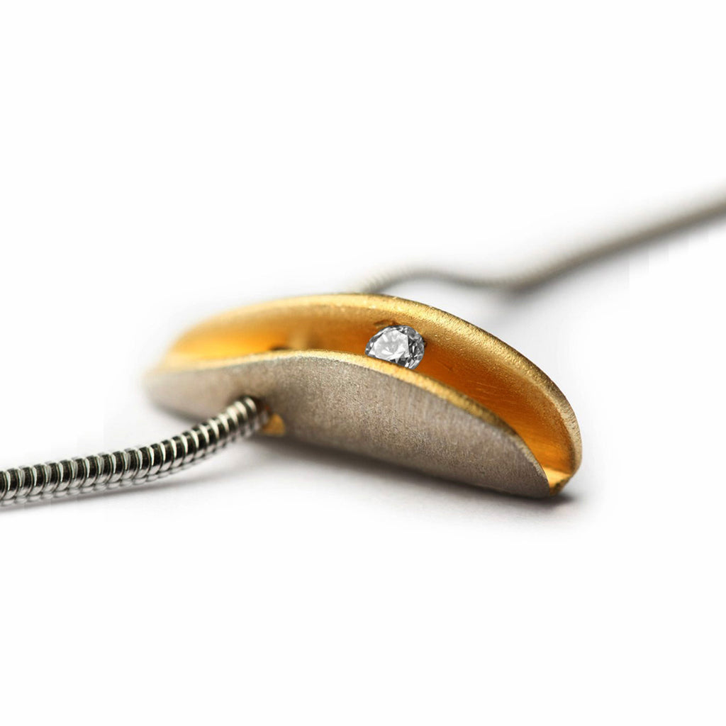 close up of silver shell pendant with 2pt diamond and a rich gold plated interior by Paul Finch contemporary jeweller