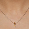 silver shell pendant with 2pt diamond and a rich gold plated interior by Paul Finch contemporary jeweller shown worn