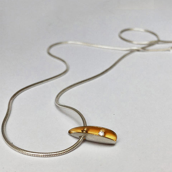 Necklace with silver shell pendant with 2pt diamond and a rich gold plated interior pendant 