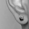 Close-up of an ear wearing a  Square silver stud in 925 sterling silver by Paul Finch
