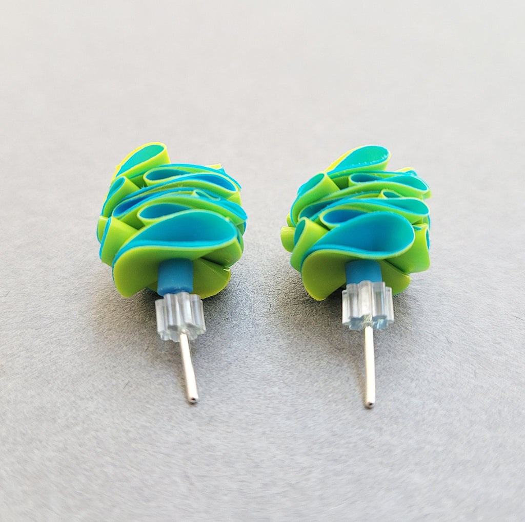Back view of studs in yellow and mid blue made from recycled polythene bags with silver earring posts by contemporary jewellery designer Rachel Darbourne
