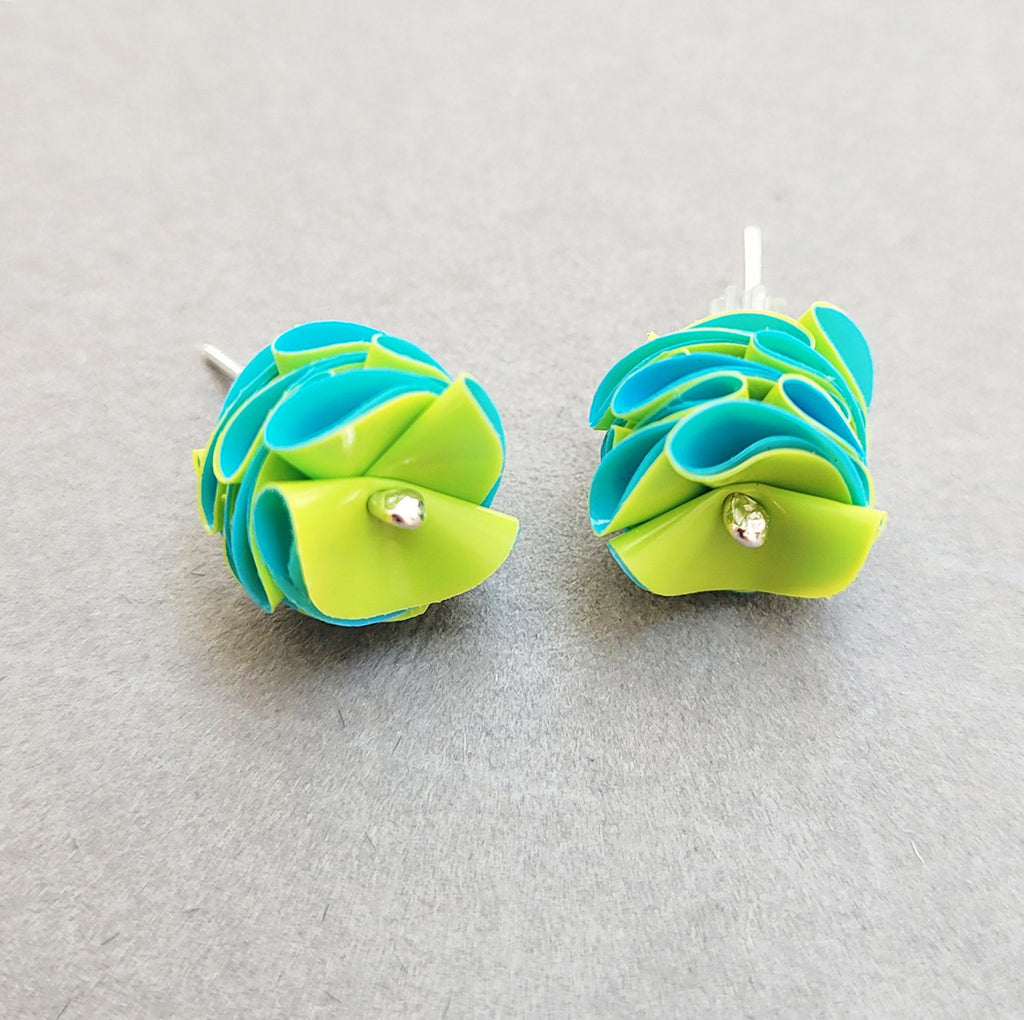 Pretty studs in yellow and mid blue are made from recycled polythene bags with silver earring posts by contemporary jewellery designer Rachel Darbourne